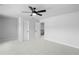 Spacious carpeted bedroom featuring modern ceiling fan, closet, and access to upper level at 6100 Marigold Way, Atlanta, GA 30349