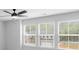 Bright bedroom featuring multiple windows with great natural light and modern ceiling fan at 6100 Marigold Way, Atlanta, GA 30349