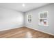 Sunlit bedroom with hardwood floors and two windows offering natural light and pleasant views at 6100 Marigold Way, Atlanta, GA 30349
