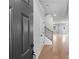 Bright foyer features hardwood floors, staircase with dark metal balusters, and a neutral color scheme at 6100 Marigold Way, Atlanta, GA 30349