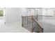 Hallway features wood and wrought iron banister and neutral carpet at 6100 Marigold Way, Atlanta, GA 30349