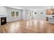 Open-concept living space featuring a cozy fireplace and direct access to the backyard through a door at 6100 Marigold Way, Atlanta, GA 30349