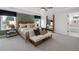 Comfortable main bedroom features a king bed, a large mirror, and natural light from the windows at 6100 Marigold Way, Atlanta, GA 30349