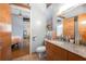 Modern bathroom featuring a wood vanity, granite countertop, and a view into the spacious bedroom at 1596 Cleveland Ave # 204, Atlanta, GA 30344