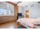 Cozy bedroom with exposed brick accent wall, hardwood floors, and natural light at 1596 Cleveland Ave # 204, Atlanta, GA 30344