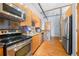 A bright kitchen with stone countertops, wood cabinetry and stainless steel appliances at 1596 Cleveland Ave # 204, Atlanta, GA 30344