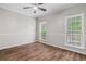 Bedroom features wood-look flooring and natural light from two windows at 280 Old Carrollton Rd, Carrollton, GA 30116
