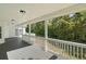 Inviting covered porch with white railings and a view of the serene, green backyard at 280 Old Carrollton Rd, Carrollton, GA 30116