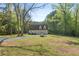 A large well manicured front yard leads up to the two-car garage, on a sunny day at 280 Old Carrollton Rd, Carrollton, GA 30116