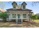 Charming home with a covered front porch, white siding, and a well-manicured lawn at 280 Old Carrollton Rd, Carrollton, GA 30116