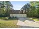 A pristine two-car garage is attached to this home with an ample driveway and manicured landscaping at 280 Old Carrollton Rd, Carrollton, GA 30116