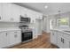 Bright open-concept kitchen featuring stainless steel appliances and white cabinets at 280 Old Carrollton Rd, Carrollton, GA 30116