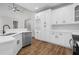 Modern kitchen featuring stainless steel appliances, white cabinets, and hardwood floors at 280 Old Carrollton Rd, Carrollton, GA 30116