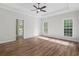 Spacious main bedroom featuring a tray ceiling, hardwood floors, and neutral paint at 280 Old Carrollton Rd, Carrollton, GA 30116