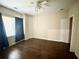 Bedroom with ceiling fan and wood flooring, with view of a window with dark curtains at 5122 Micaela Way, Duluth, GA 30096