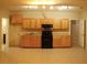 Functional kitchen featuring wood cabinets, tile flooring, and a full appliance suite at 5122 Micaela Way, Duluth, GA 30096