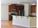 Well-appointed eat-in kitchen featuring hardwood floors, dark wood cabinets, and stainless steel appliances at 5122 Micaela Way, Duluth, GA 30096
