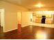 Spacious living room featuring wood flooring that transitions into a functional kitchen at 5122 Micaela Way, Duluth, GA 30096