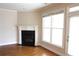 Cozy living room with a fireplace, a large window with natural light, and hardwood floors at 5122 Micaela Way, Duluth, GA 30096