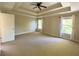 Spacious primary bedroom featuring a tray ceiling, neutral paint, carpet and multiple windows at 5122 Micaela Way, Duluth, GA 30096