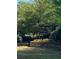 Community entrance sign surrounded by a greenway and manicured flower garden at 5122 Micaela Way, Duluth, GA 30096