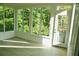 Sunroom featuring hardwood floors and large windows showcasing the lush, green surroundings at 5122 Micaela Way, Duluth, GA 30096