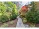 Beautiful backyard with brick home, paver path, and mature landscaping at 811 Flathead Pass, Suwanee, GA 30024