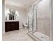 Modern bathroom with tiled walk-in shower, dark wood vanity, and neutral color palette at 811 Flathead Pass, Suwanee, GA 30024