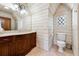 Elegant bathroom featuring a dark vanity, large mirror, and a window with lattice design at 811 Flathead Pass, Suwanee, GA 30024