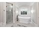 Elegant bathroom featuring a soaking tub, glass shower, and stylish lighting fixtures at 811 Flathead Pass, Suwanee, GA 30024