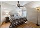 Charming bedroom with plank walls, hardwood floors, and a comfortable queen size bed at 811 Flathead Pass, Suwanee, GA 30024