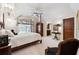 Bedroom featuring a four-poster bed, ceiling fan, and a doorway to an ensuite bathroom at 811 Flathead Pass, Suwanee, GA 30024