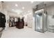 Large walk-in closet with custom shelving, center island, and a modern elevator at 811 Flathead Pass, Suwanee, GA 30024
