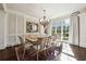 Formal dining room with chandelier, large window, and seating for ten at 811 Flathead Pass, Suwanee, GA 30024