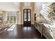 Elegant foyer with iron doors, hardwood floors, and a bright, airy ambiance at 811 Flathead Pass, Suwanee, GA 30024