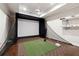 Spacious golf simulator room with projector, screen, and turf for practicing your swing at 811 Flathead Pass, Suwanee, GA 30024