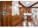 Living room features dark wood cabinets, stainless steel appliances, and dark hardwood flooring at 811 Flathead Pass, Suwanee, GA 30024
