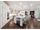 Spacious, bright kitchen with a large marble island, stainless steel appliances, and white cabinetry at 811 Flathead Pass, Suwanee, GA 30024