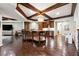 Open concept living room with a kitchen area featuring dark wood cabinets and stainless appliances at 811 Flathead Pass, Suwanee, GA 30024