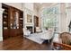 Spacious living room with a fireplace, built-in shelving, and large windows at 811 Flathead Pass, Suwanee, GA 30024