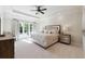 Elegant main bedroom features a tray ceiling, large windows, and luxurious furnishings at 811 Flathead Pass, Suwanee, GA 30024