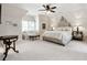 Bright main bedroom with a cozy sitting area, large bed, and elegant bedside tables at 811 Flathead Pass, Suwanee, GA 30024