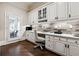 Bright home office with custom cabinetry, granite countertops, and a stylish workspace at 811 Flathead Pass, Suwanee, GA 30024