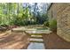 Stone steps lead to backyard putting green at 811 Flathead Pass, Suwanee, GA 30024