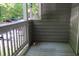 Cozy outdoor balcony space with patterned rug and wooded view at 310 Warm Springs Cir, Roswell, GA 30075