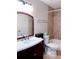 Bathroom with wood vanity, large mirror, and tiled shower at 310 Warm Springs Cir, Roswell, GA 30075