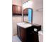 Bathroom featuring wood vanity, large mirror, modern lighting, and tiled floors at 310 Warm Springs Cir, Roswell, GA 30075