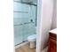 This bathroom features a glass-enclosed shower with white tiling and modern fixtures at 310 Warm Springs Cir, Roswell, GA 30075