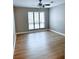 This neutral bedroom offers wood floors and a window for natural light at 310 Warm Springs Cir, Roswell, GA 30075