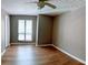 Neutral bedroom features wood floors, a window, and natural light at 310 Warm Springs Cir, Roswell, GA 30075